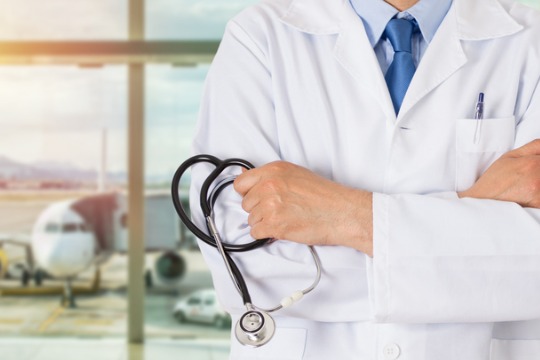 unrecognizable-male-doctor-standing-with-his-arms-folded-inside-of-a-airport 540x360